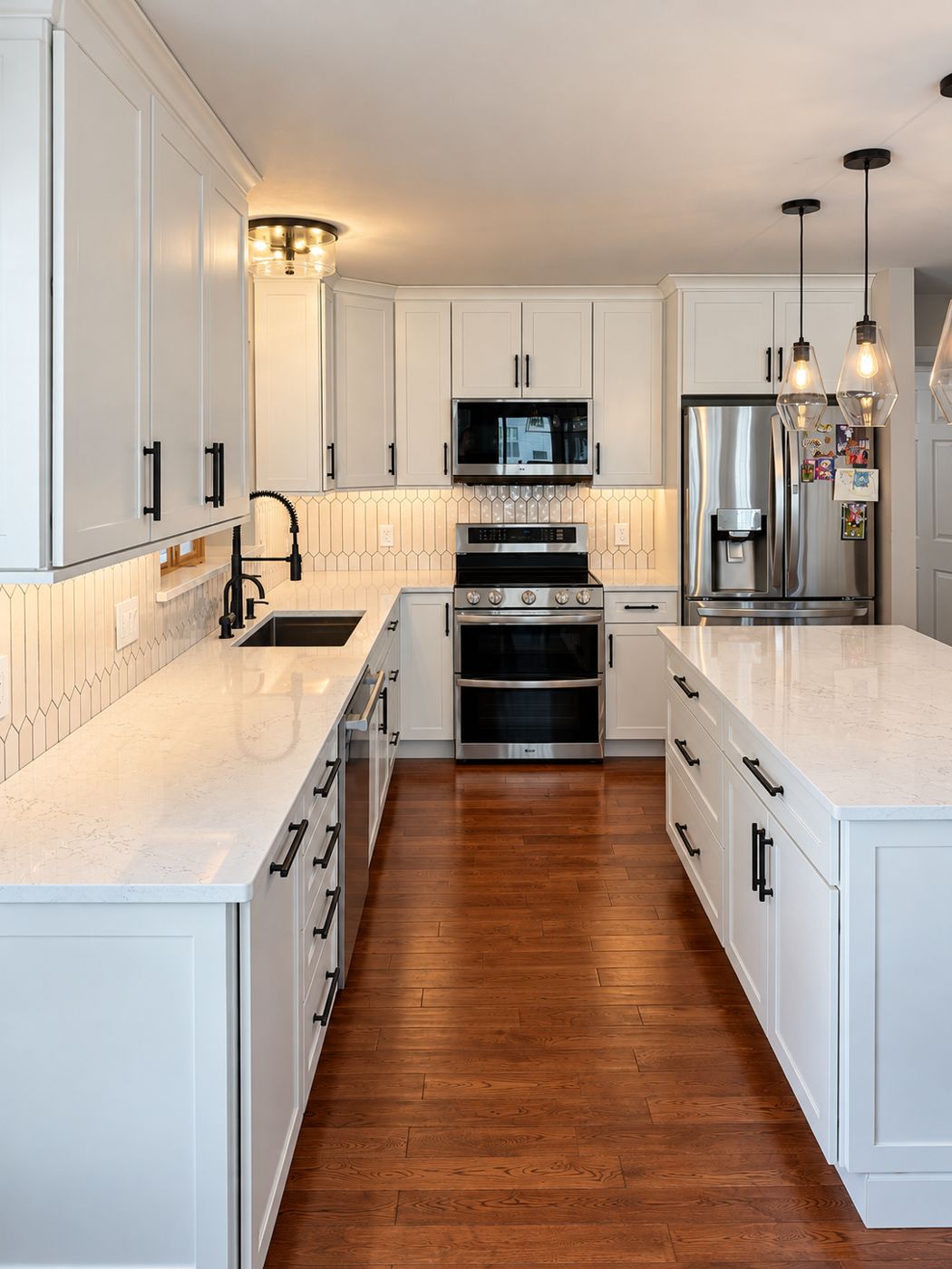 White shaker kitchen looking toward the range and refrigerator